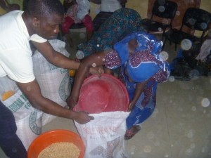A woman collects her portion of maize.